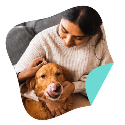 A person cuddling a dog